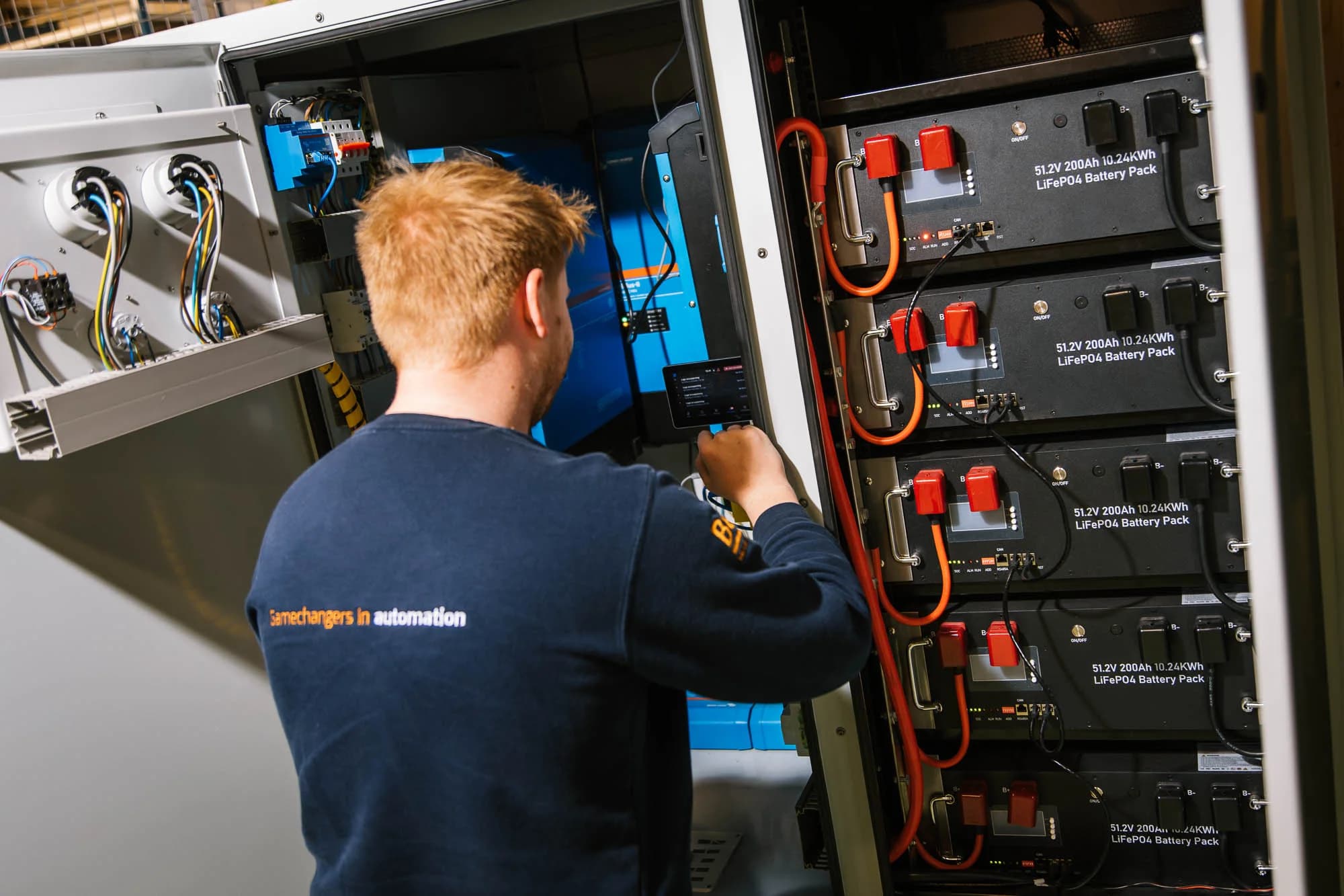 Nick working on a battery system with Victron components. Original GCG photography.